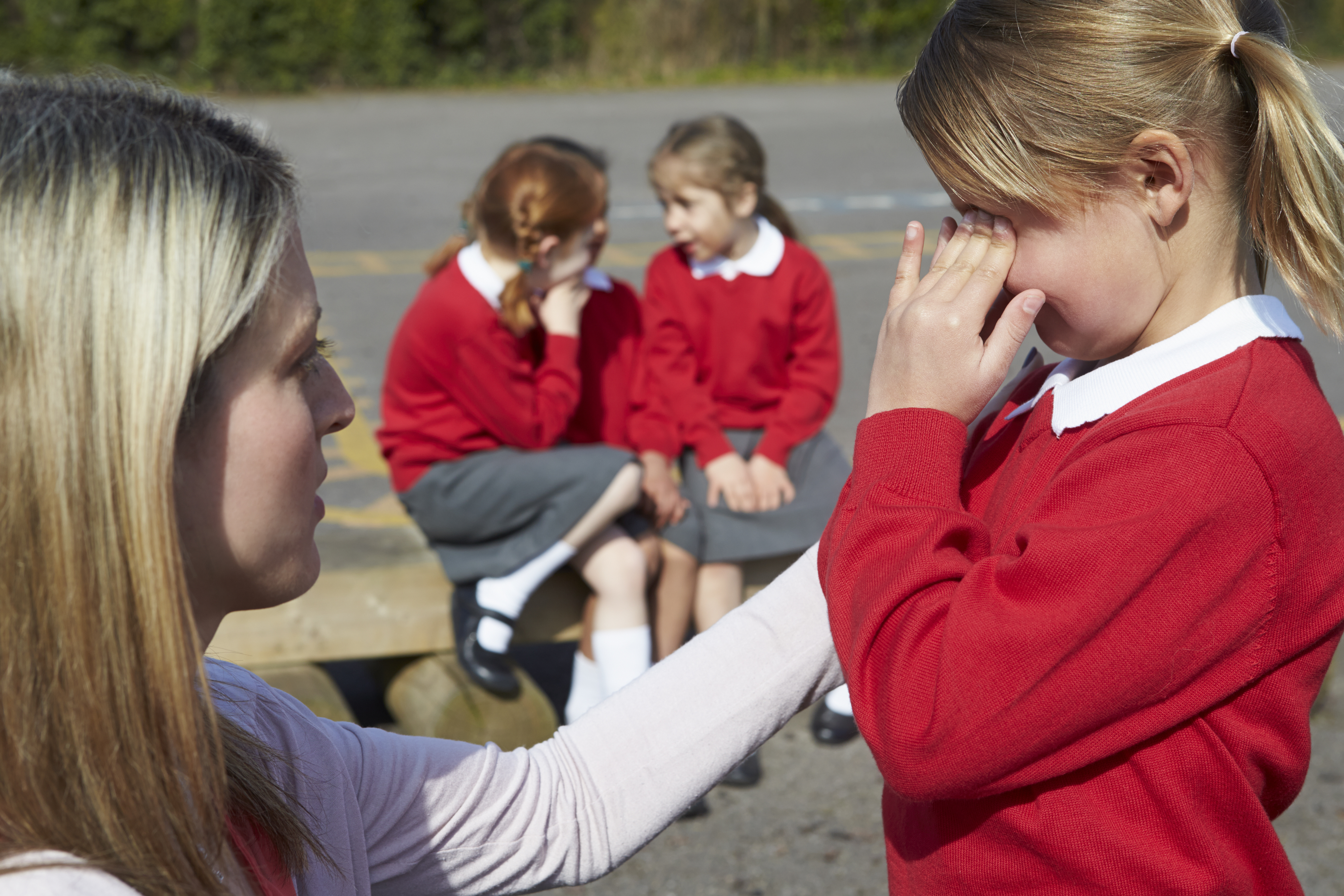 teacher comforts bullied child
