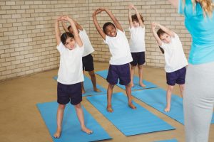 students stretching before yoga class