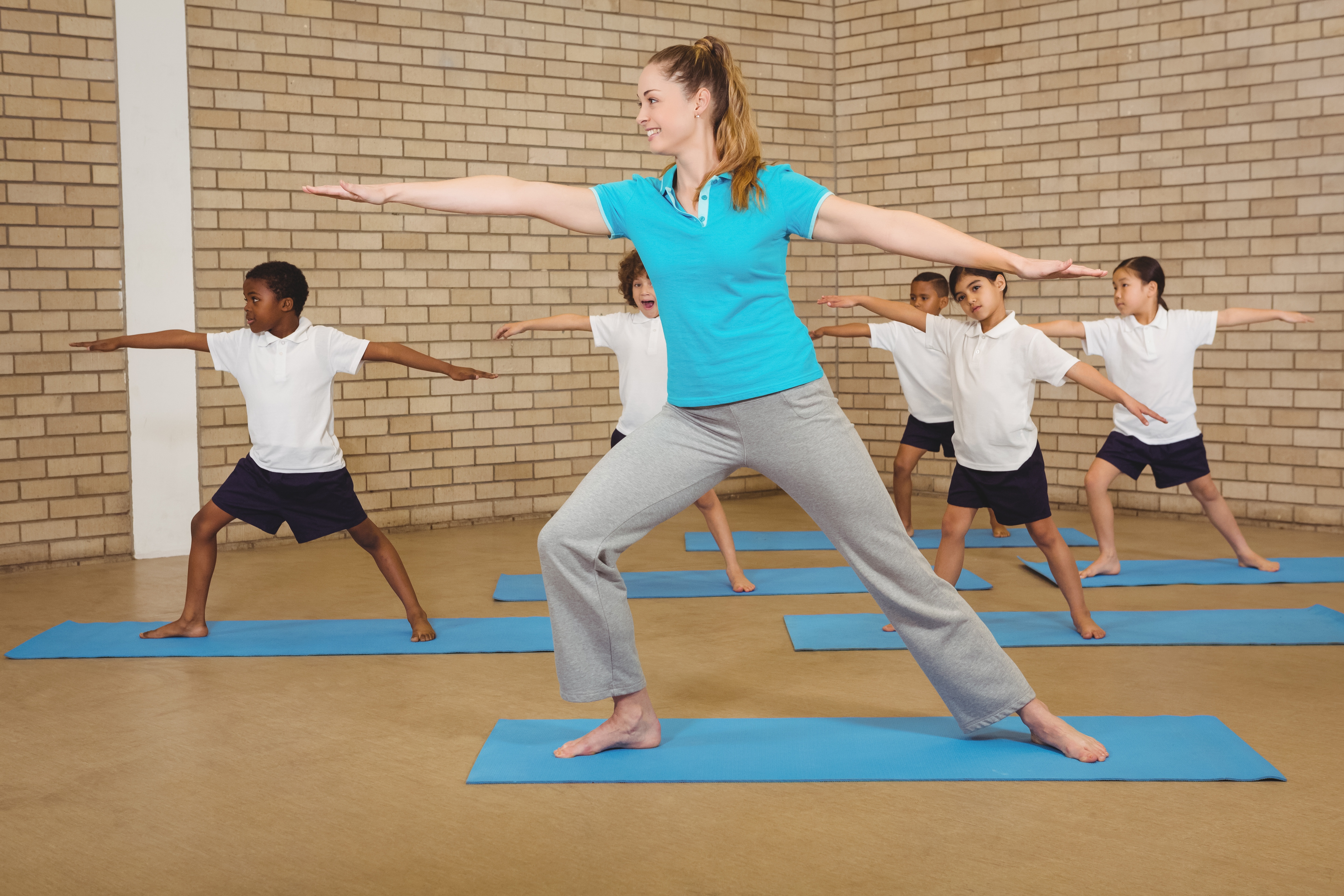 Students and teacher doing yoga pose