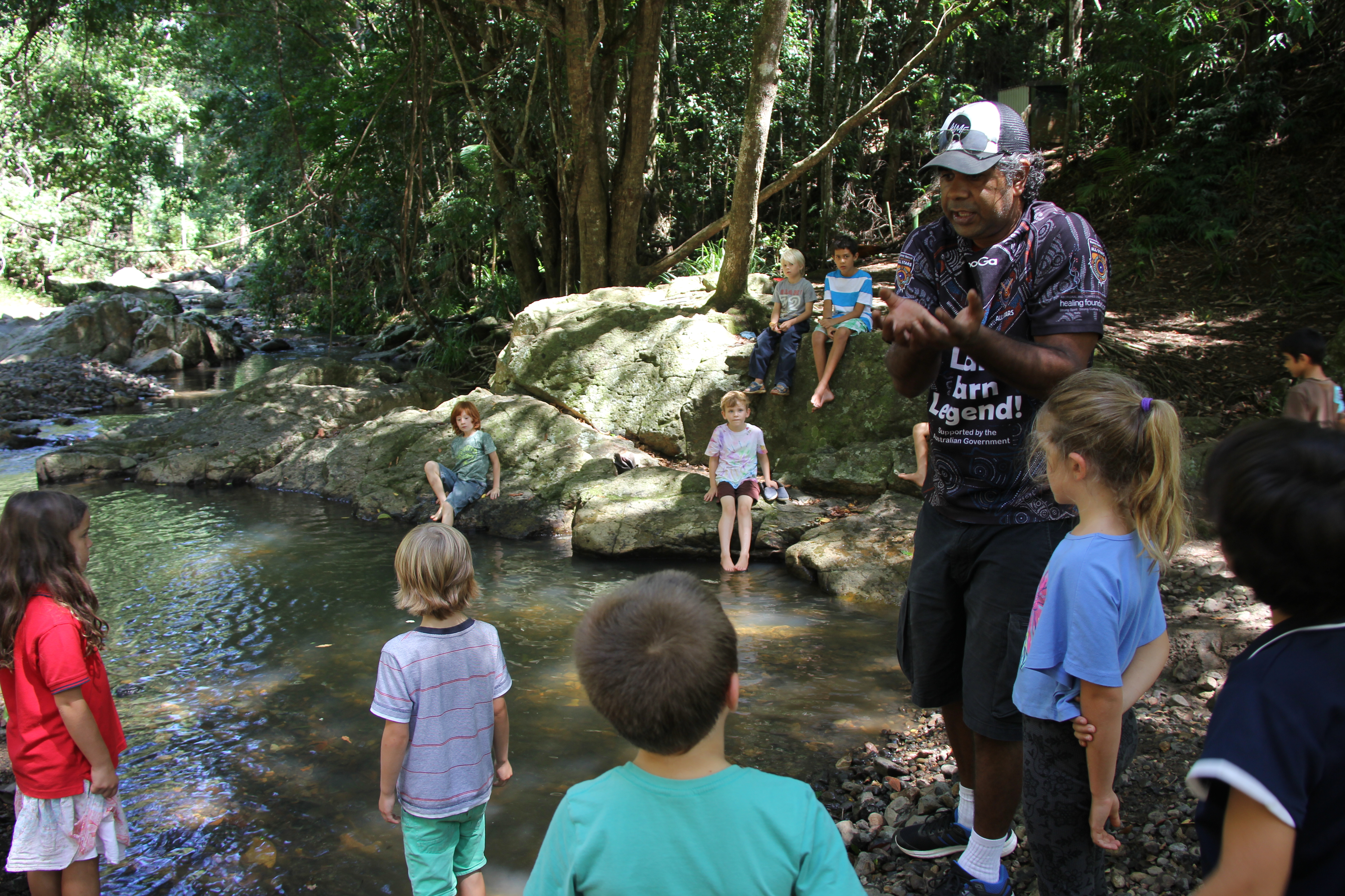 Kabi Kabi educator Lyndon Davis with River School kids at their creek