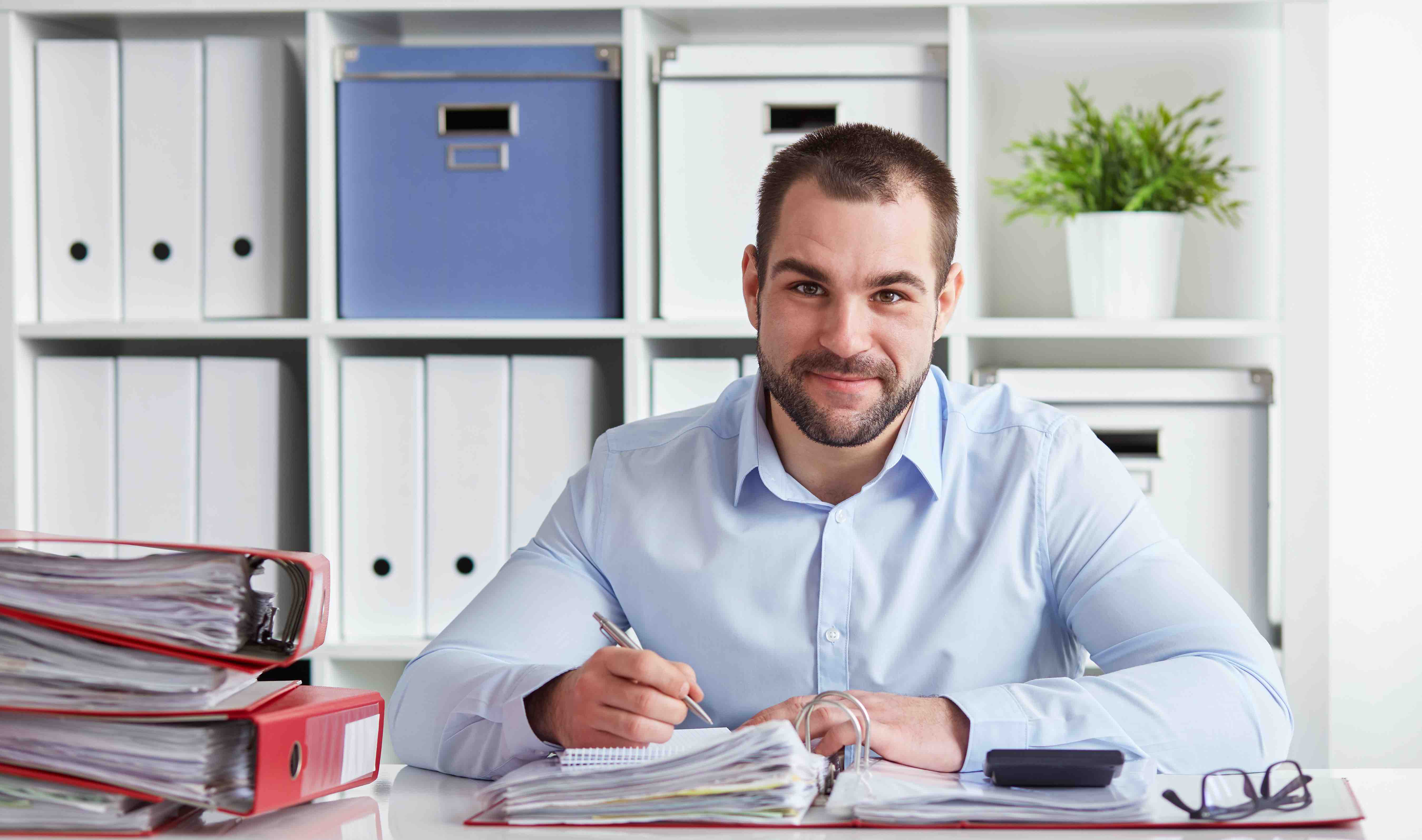 Teacher writing in his planner