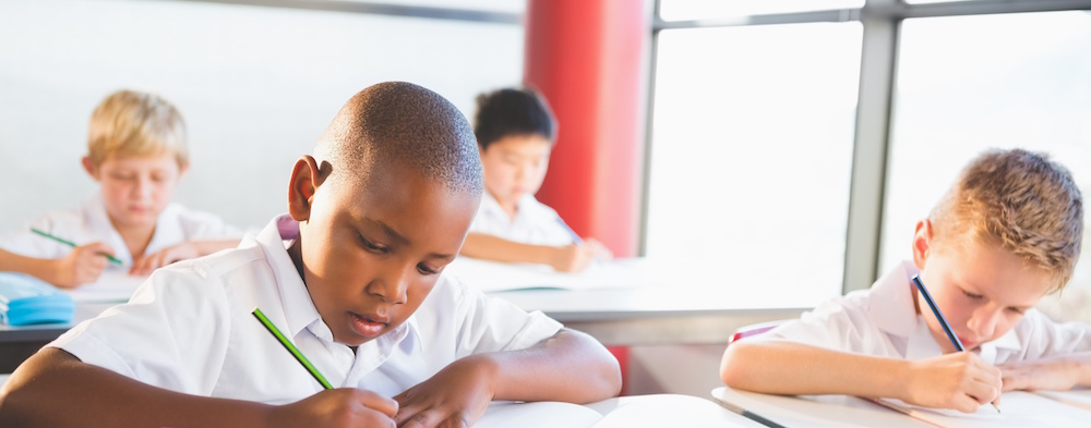 School kids doing homework in classroom