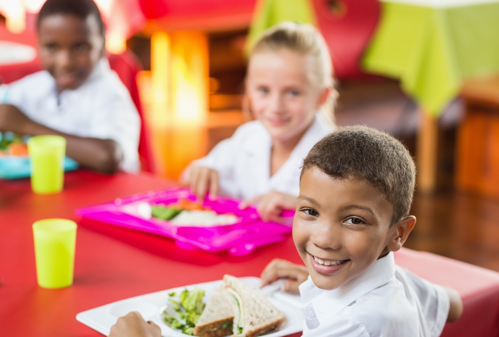 Children having healthy lunch during break time in school