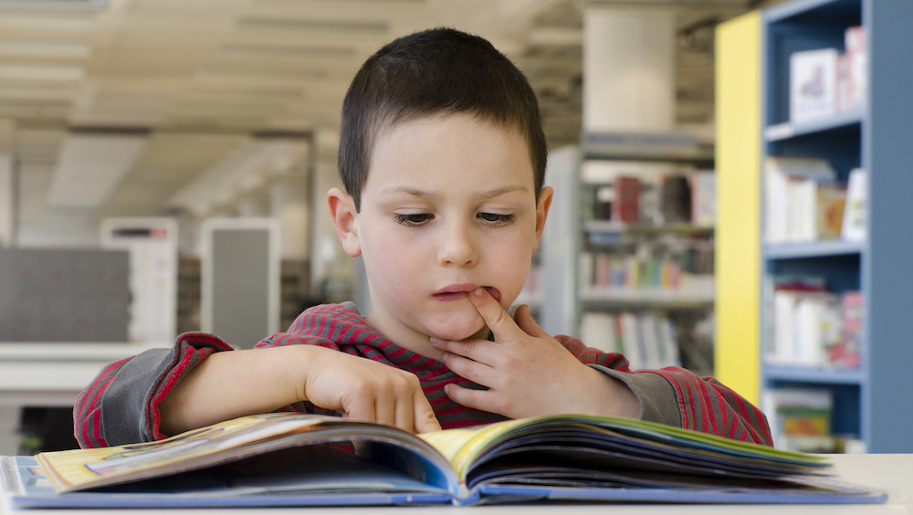 Child reading school library