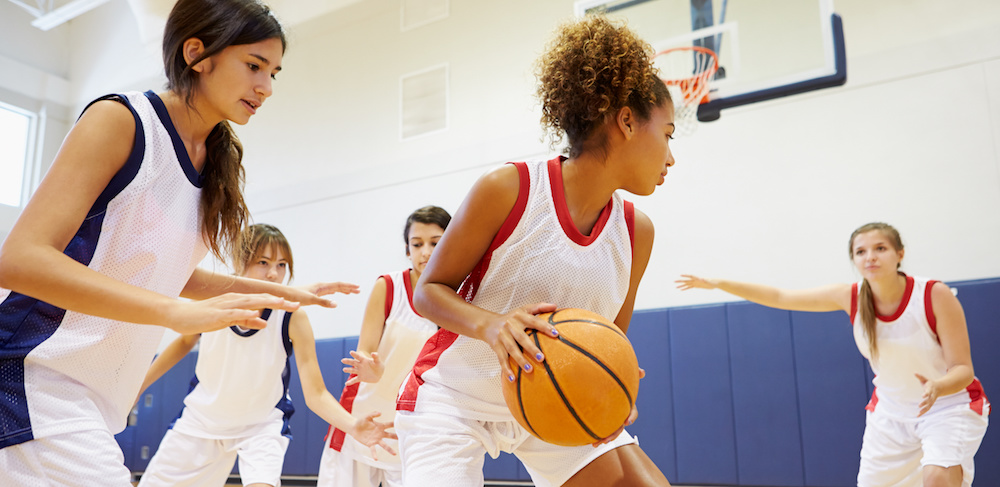 Female High School Basketball Team Playing Game