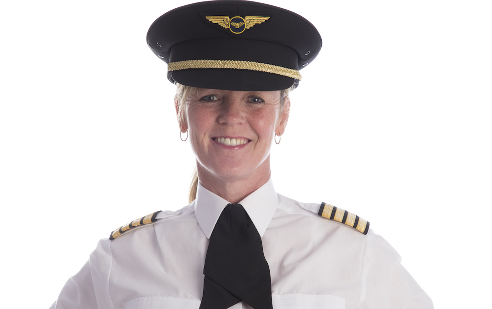 Female pilot in uniform and wearing her hat