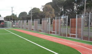 Custom timber panels with galvanised tubular steel and weld mesh. Photo: Lee Brothers Group Fencing