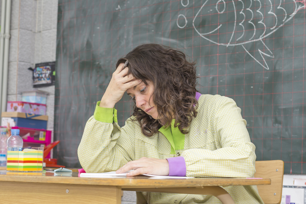 Tired teacher in classroom