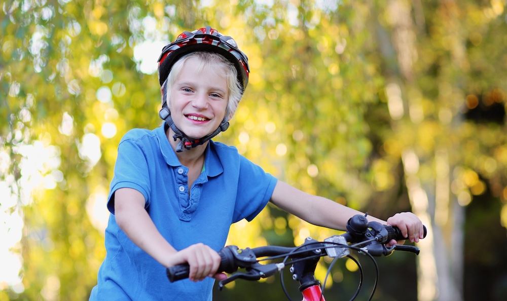 Happy boy riding on bike