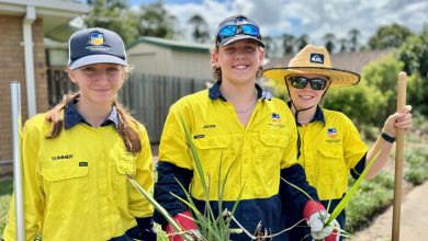 three students gardening