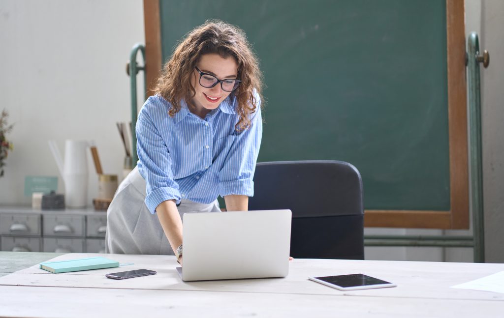 Smiling teacher with laptop