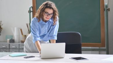 Smiling teacher with laptop