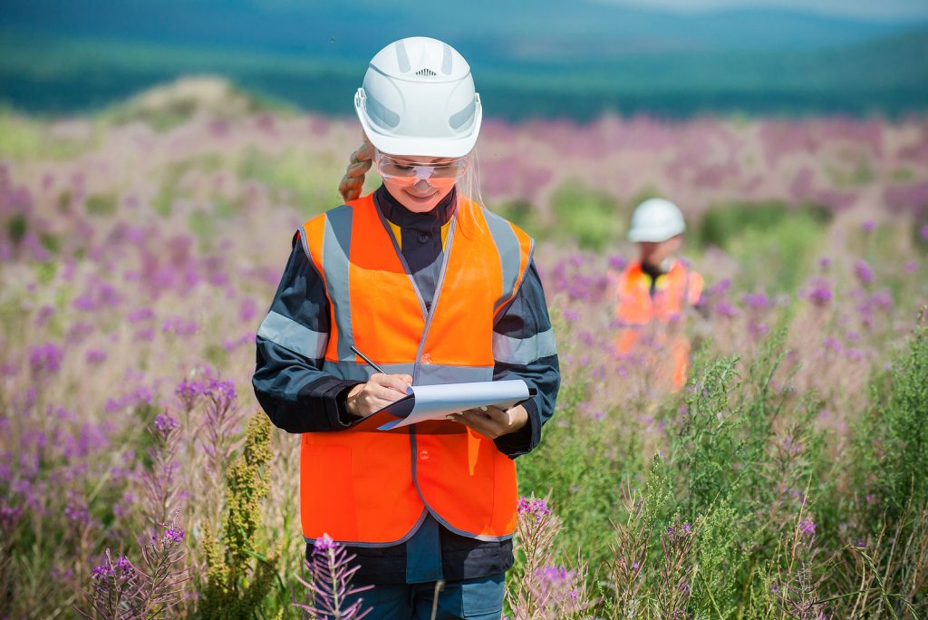 Students researching recultivated field in Russia during educational travel expedition.