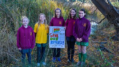 Students holding sign, reading Save our Rivers