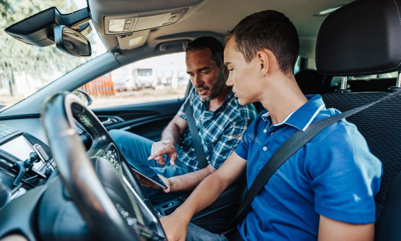 Driving instructor in car with student