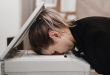 Person with head inside photocopier