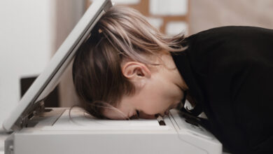 Person with head inside photocopier