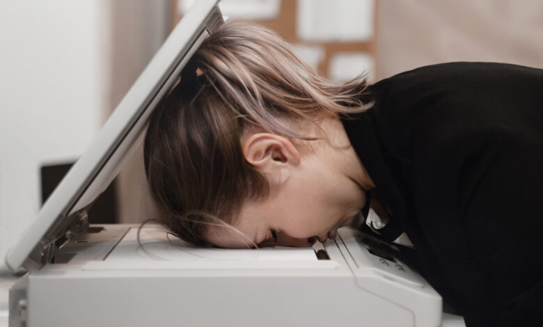 Person with head inside photocopier
